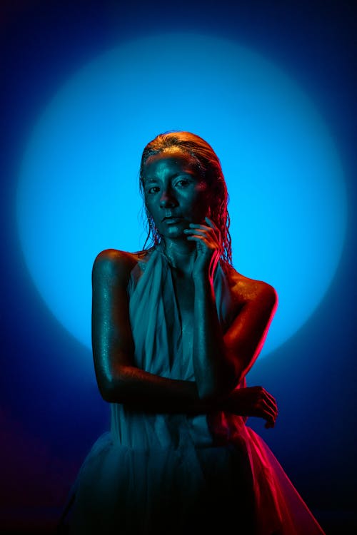 A woman in a white dress with blue lights