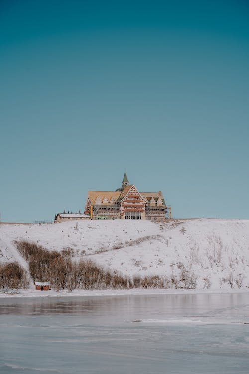 Hotel on a Hill Above a Frozen Lake