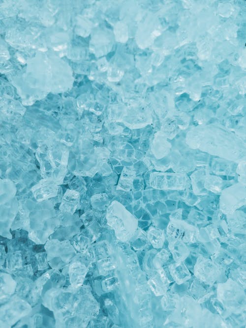 Blue ice cubes are shown in a close up