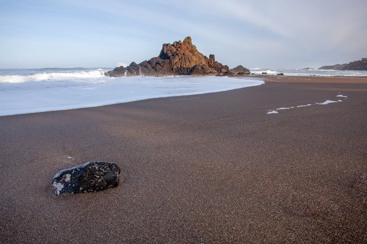 Black Rock On Sandy Beach