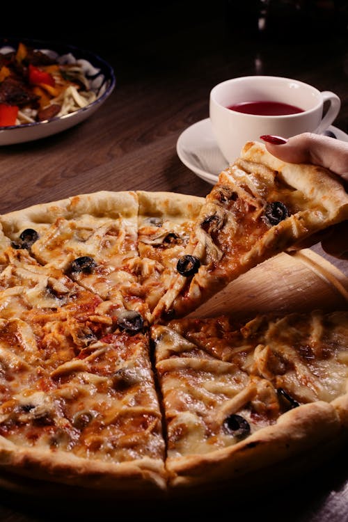 Free Taking a Slice of Pizza Stock Photo