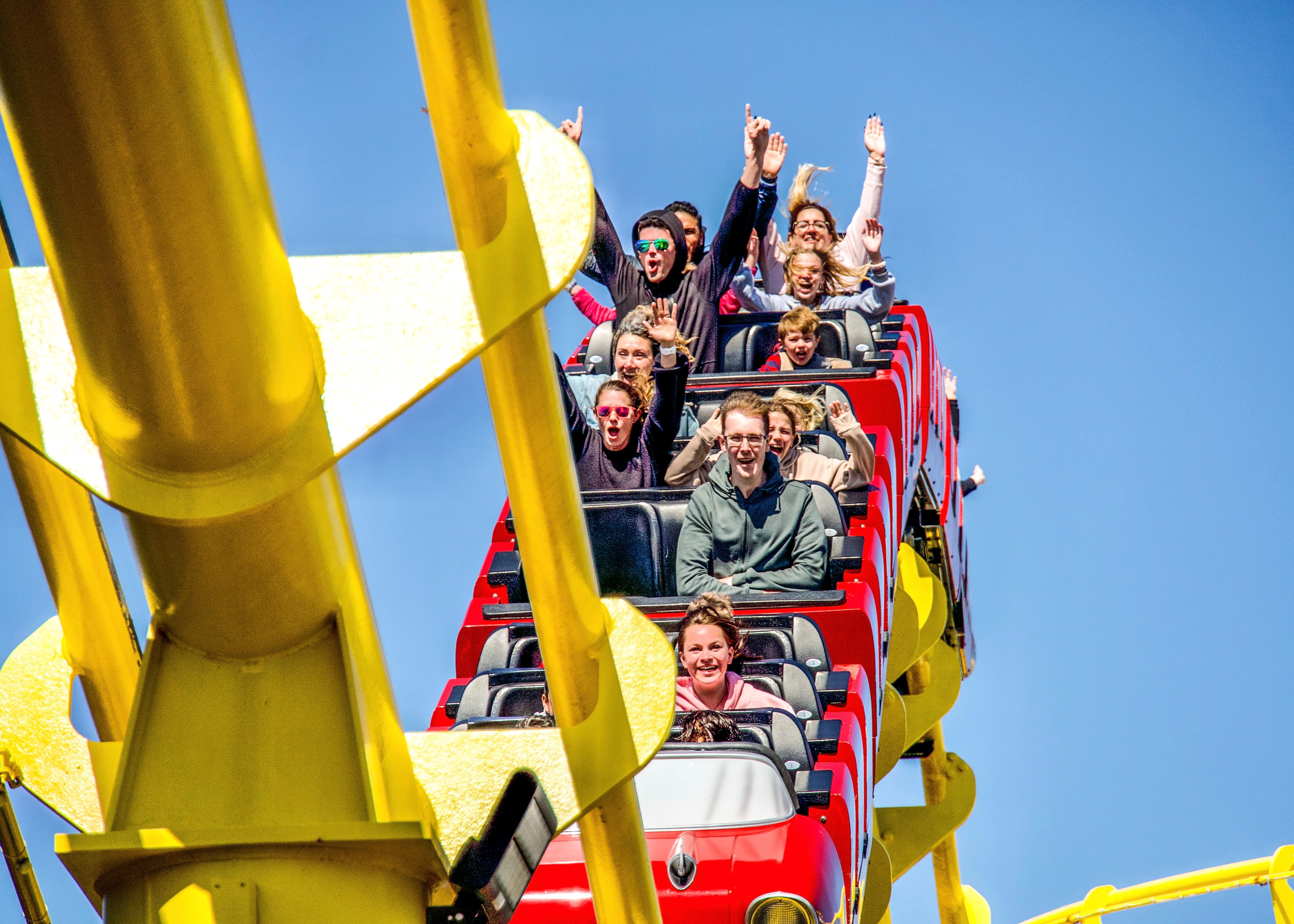 Thrilling roller coaster ride capturing the joy and excitement of passengers in Santa Monica.