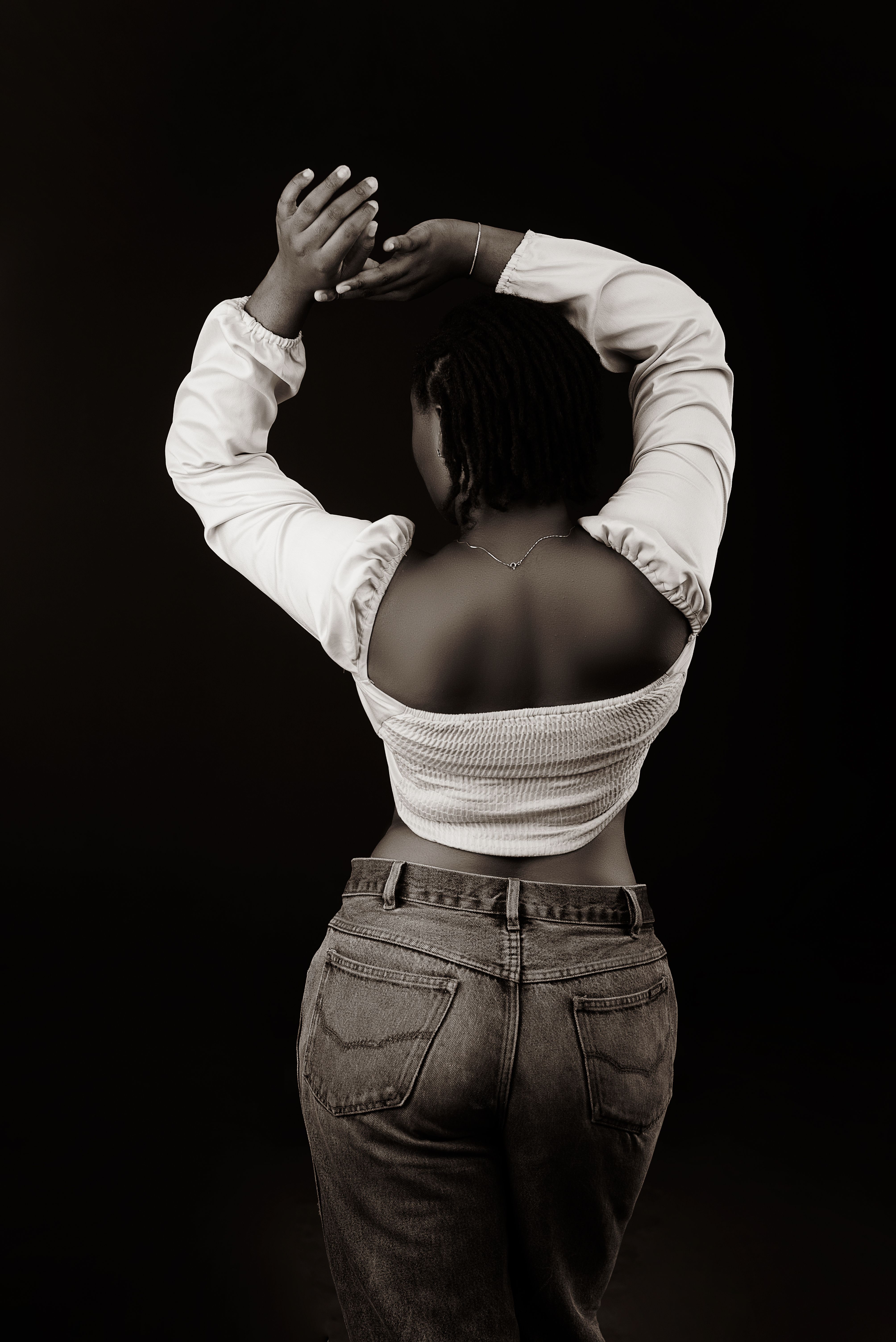 Back View of Woman Standing with Arms Raised · Free Stock Photo