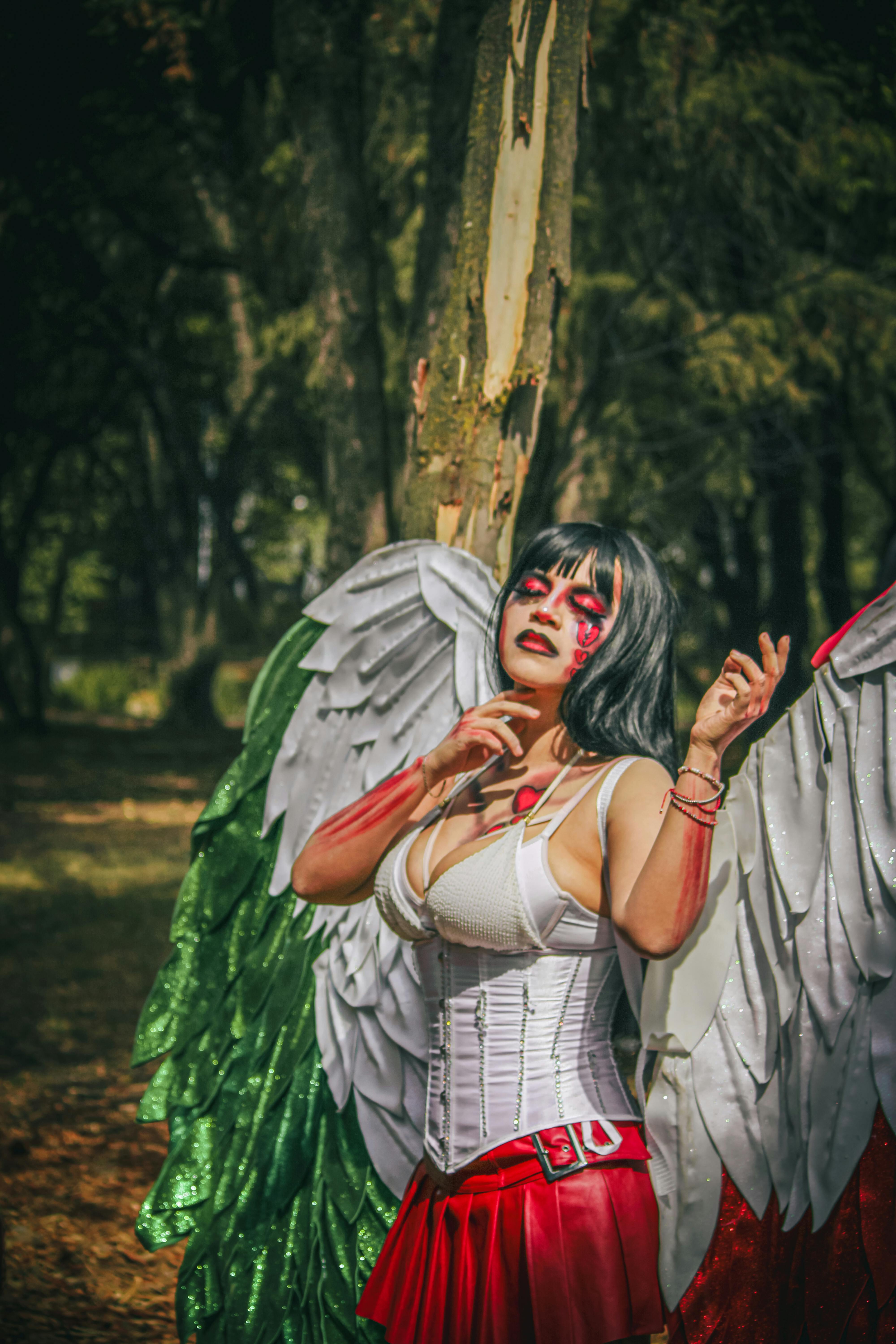 Artistic portrait with Mexican-themed wings in urban park setting.
