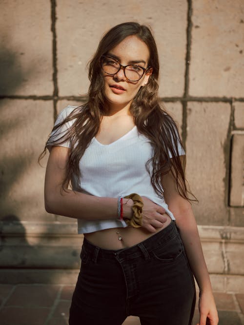 A woman in glasses and a white shirt posing for a photo