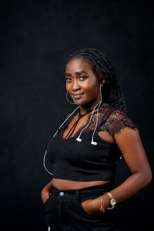 Studio Shot of a Young, Smiling Woman Wearing a Black Outfit 