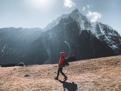 A person walking on a mountain with a backpack