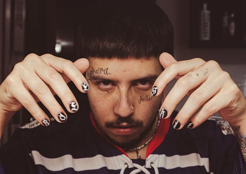 Man with Tattoos on Face and Manicure