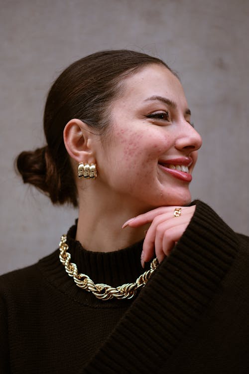 Smiling Woman with Golden Necklace and Earring