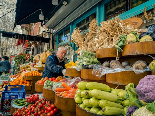 A man is shopping for vegetables at a market
