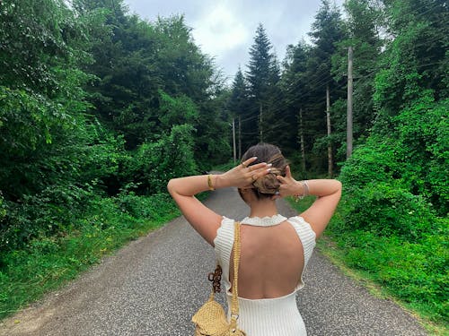 A path intertwined with nature. The girl is determined to walk along this path