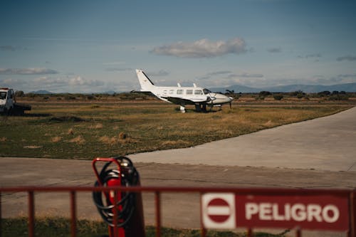 A small airplane parked on the tarmac next to a fire hydrant