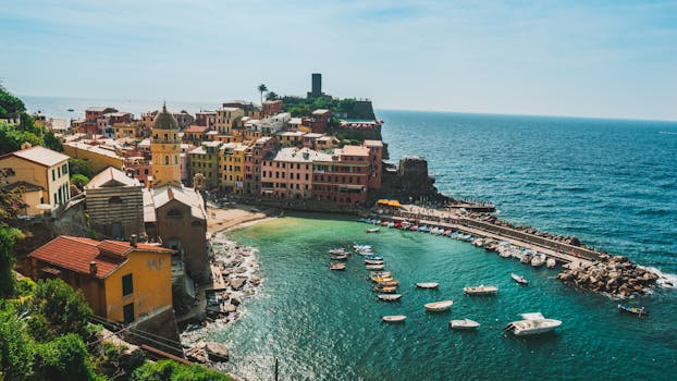 A picturesque aerial view of Vernazza's colorful buildings and harbor along the Italian coastline. by Chait Goli