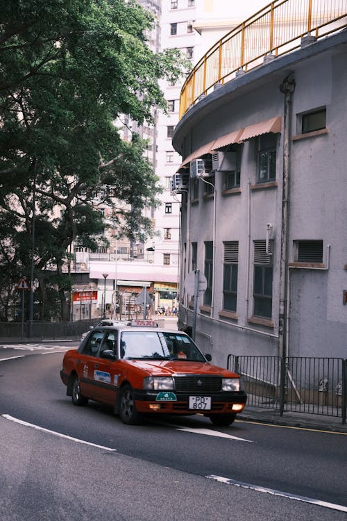 A Red Taxi on a Street in Hong Kong, China 