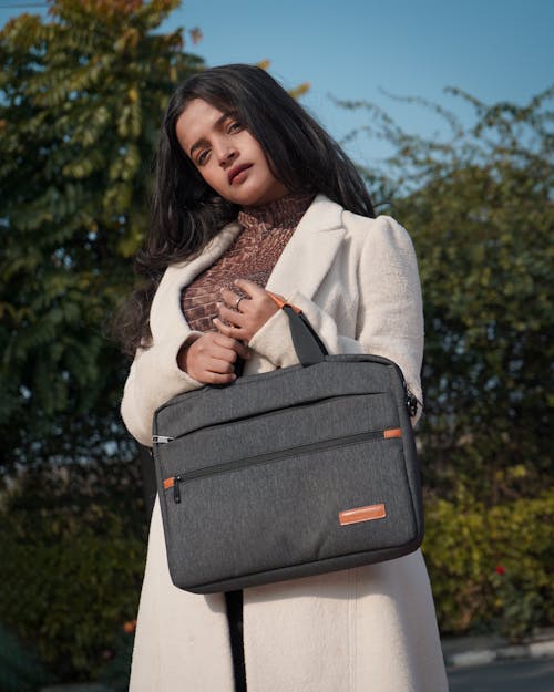 A woman holding a laptop bag in her hand