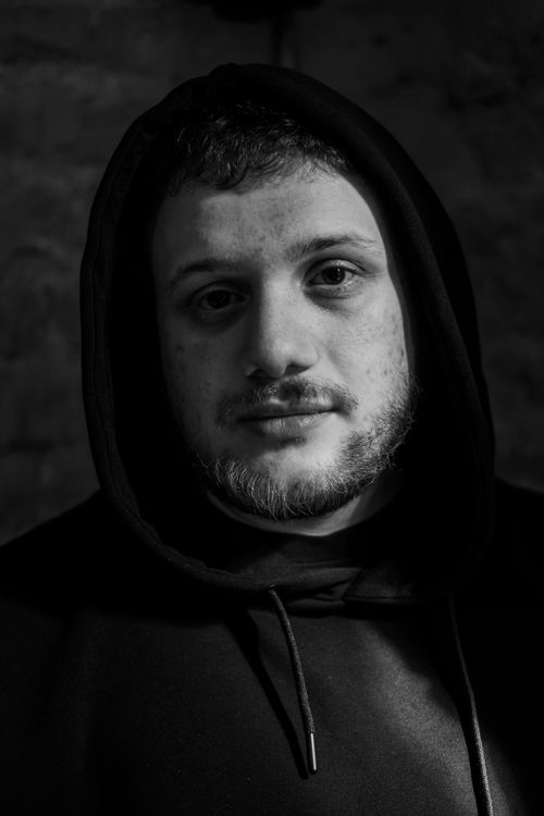 Free Striking black and white portrait of a man in a hoodie, emphasizing contrast and emotion. Stock Photo
