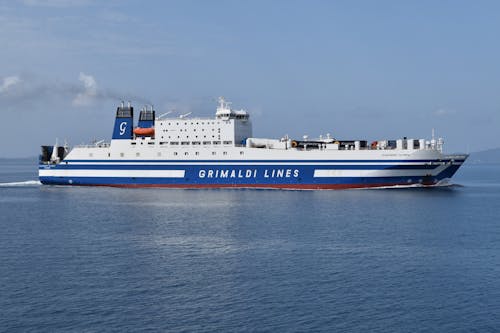 A large ferry boat is traveling on the water