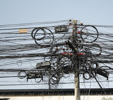 Complex network of tangled power lines and cables in Chiang Mai, Thailand.