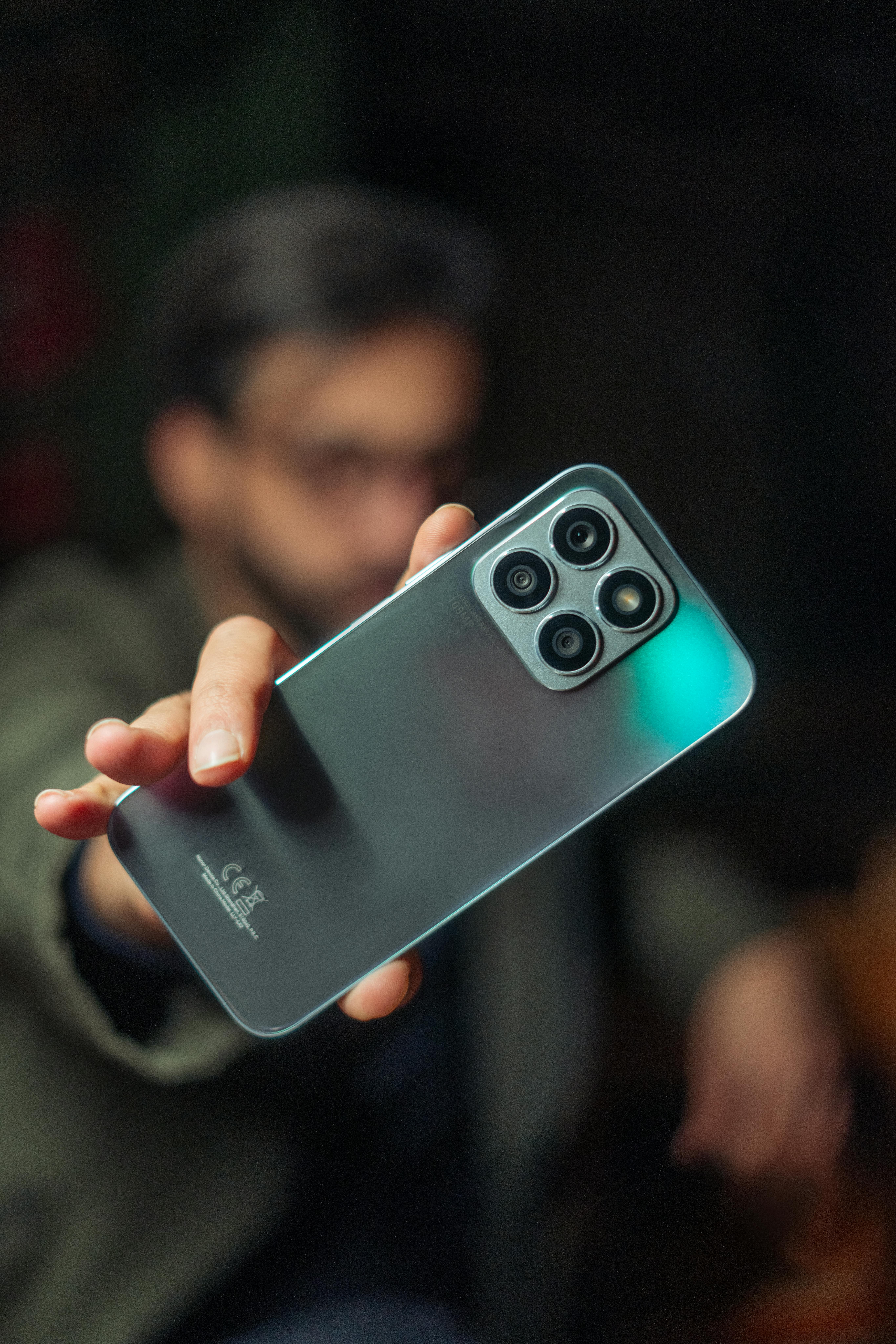 Free Selective focus close-up of a smartphone held by a man in Baghdad, Iraq. Stock Photo