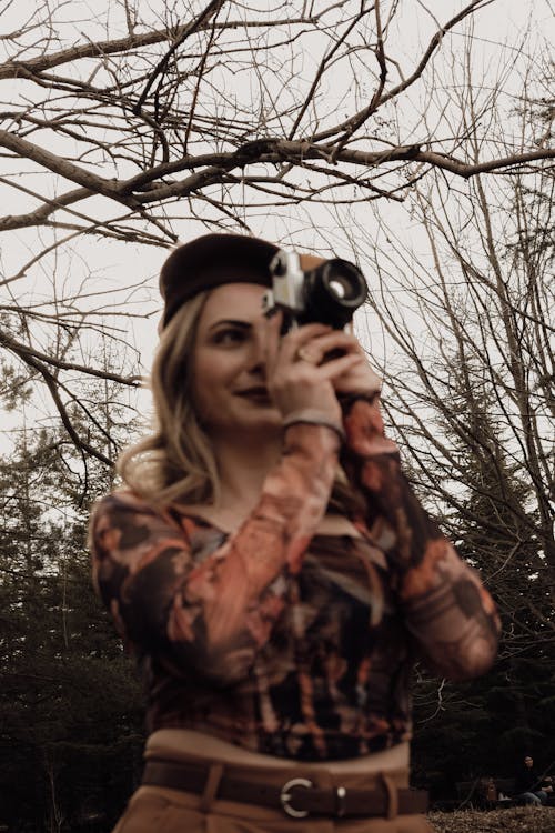 Blonde Woman Standing with Camera