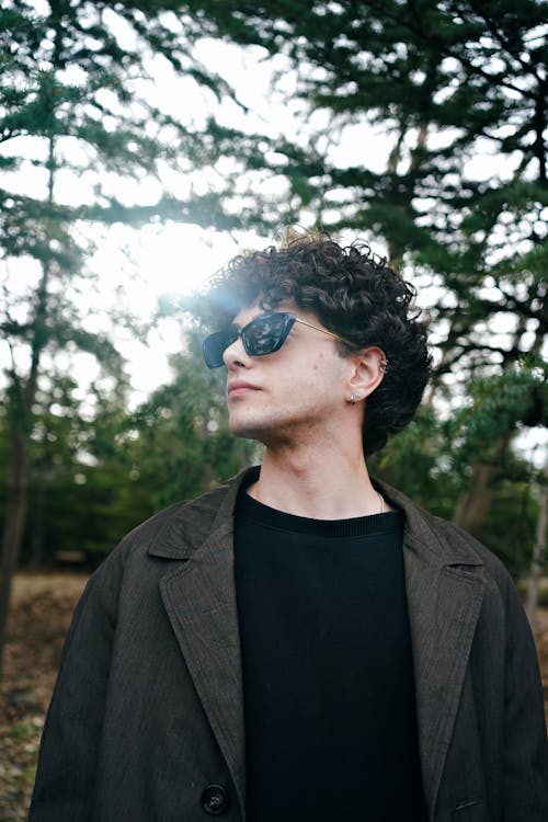 Portrait of Man in Sunglasses and with Curly Hair