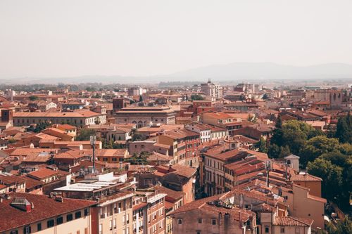 Free A breathtaking aerial view of Pisa, Italy showcasing its historic rooftops and urban layout. Stock Photo
