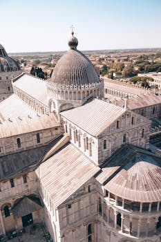Explore the majestic architecture of Pisa Cathedral with this stunning aerial shot.
