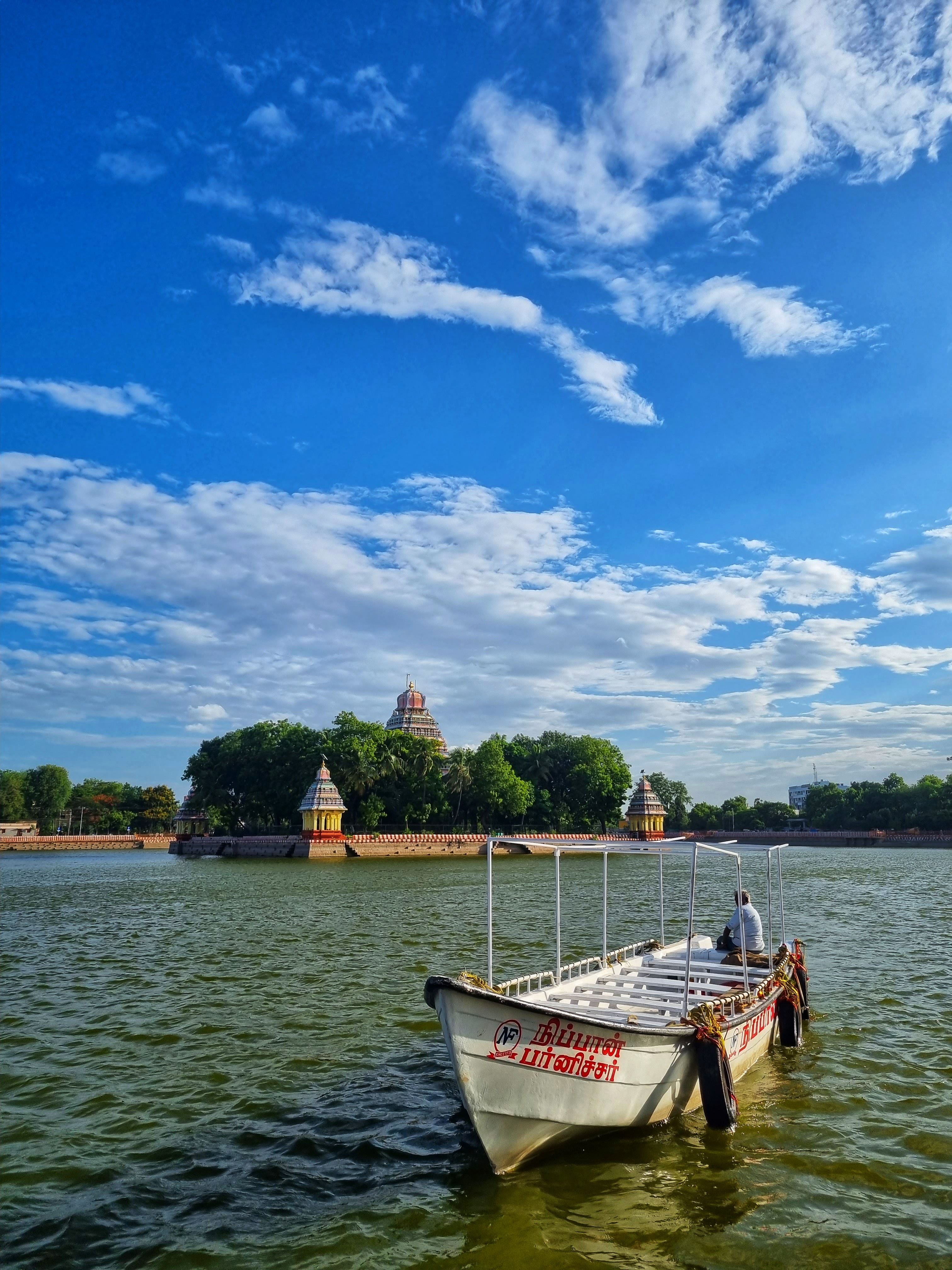Colorful boat near Meenakshi Amman Temple in Madurai, India, under a vibrant sky.