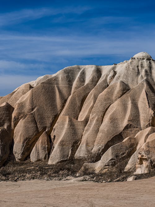 A rock formation in the desert with a blue sky