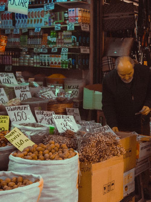 Free A man is looking at a display of fruit and vegetables Stock Photo