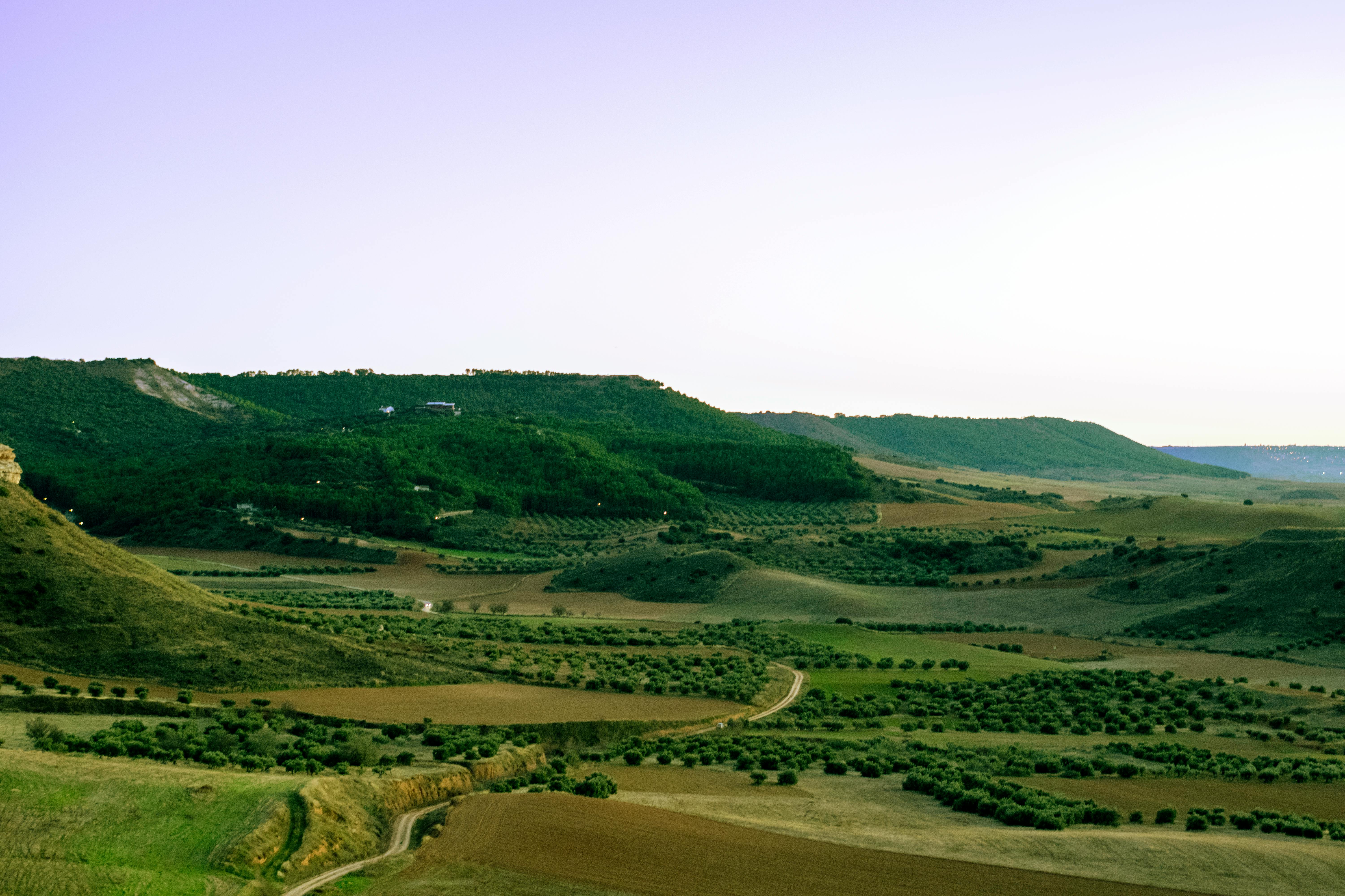 Breathtaking view of rural hills and fields near Madrid, Spain, showcasing lush greenery.