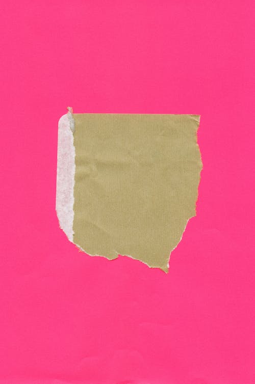 A pink paper with a piece of paper on it