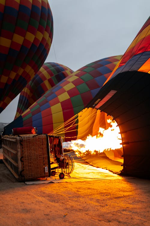A hot air balloon is being lit up by a fire