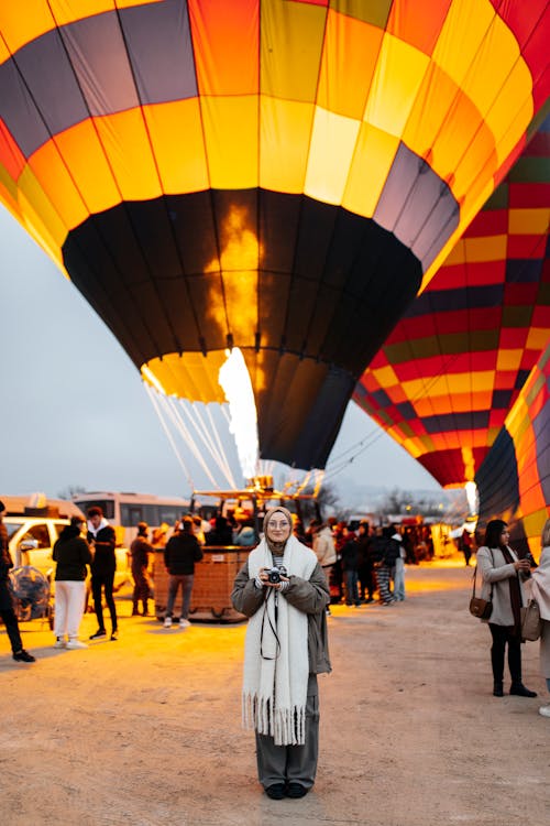 A woman standing in front of a hot air balloon