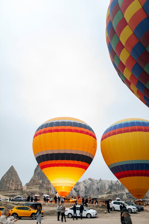 Cars and People near Hot Air Balloons in Cappadocia