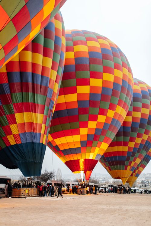 Free Vibrant hot air balloons prepared for launch, showcasing a colorful spectacle of adventure and recreation. Stock Photo
