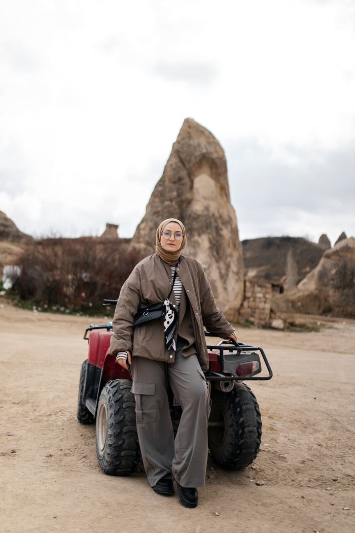 Traveller beside an ATV in the rocky Cappadocia landscape