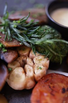 A detailed shot of a gourmet vegetable dish featuring garlic, mushrooms, and rosemary, perfect for food lovers.