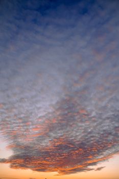 Colorful, dramatic sunset featuring a vibrant cloudscape with a gradient sky.