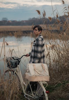 A person explores the tranquil countryside of Banatski Karlovac, Serbia on a bicycle at sunset.