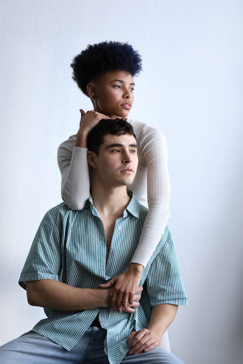 Multiracial Couple Posing in White Studio