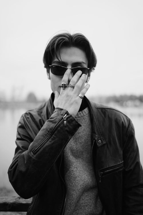 Free Black and white portrait of a man in sunglasses and leather jacket posing by the lake in Ankara. Stock Photo