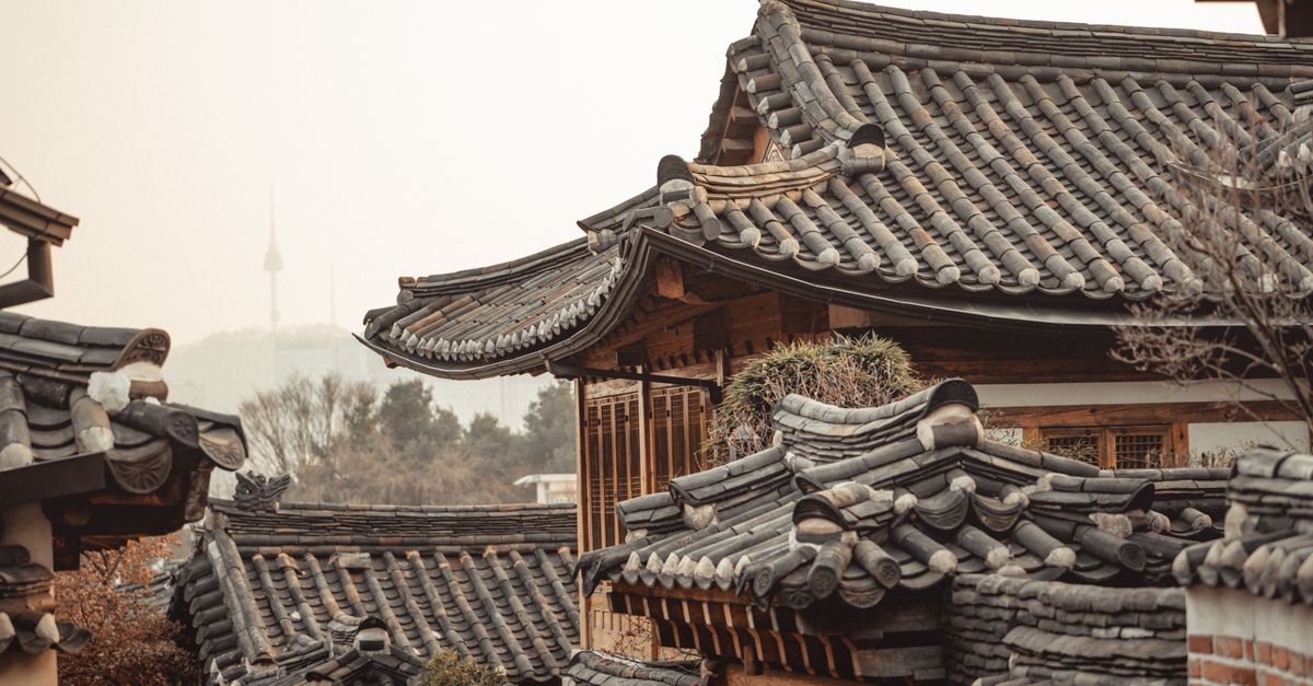 Tiled rooftops of a traditional hanok quarter in Seoul.