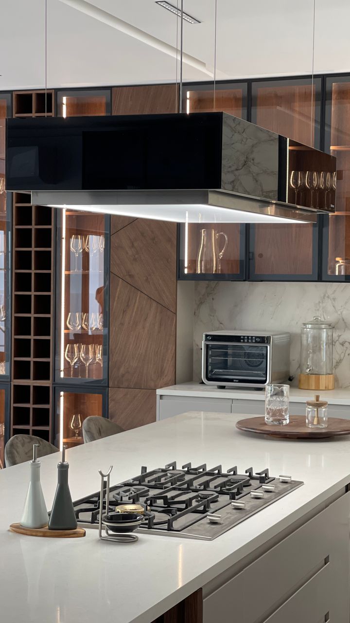 A modern kitchen matte black coffee cabinet accent with brass hardware and open shelving