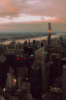 A stunning aerial view of New York City's skyline with modern skyscrapers and evening lights.