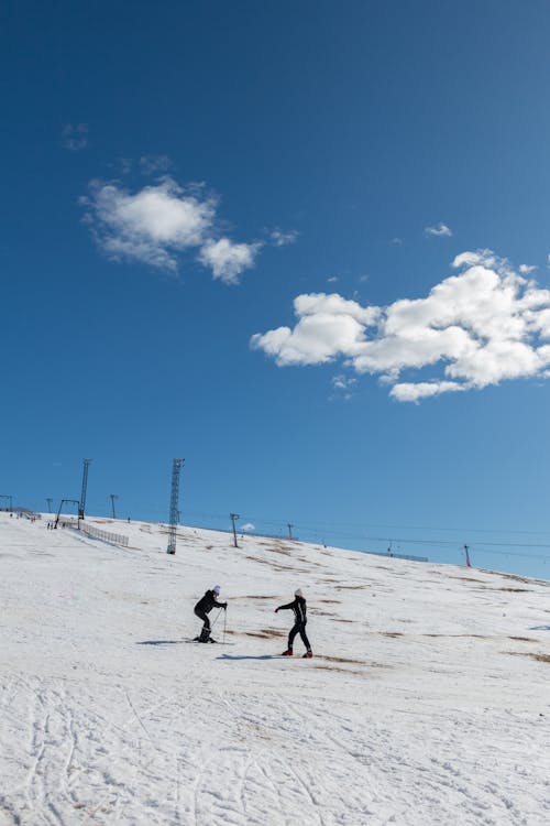 People Skiing on Ski Slope in Winter