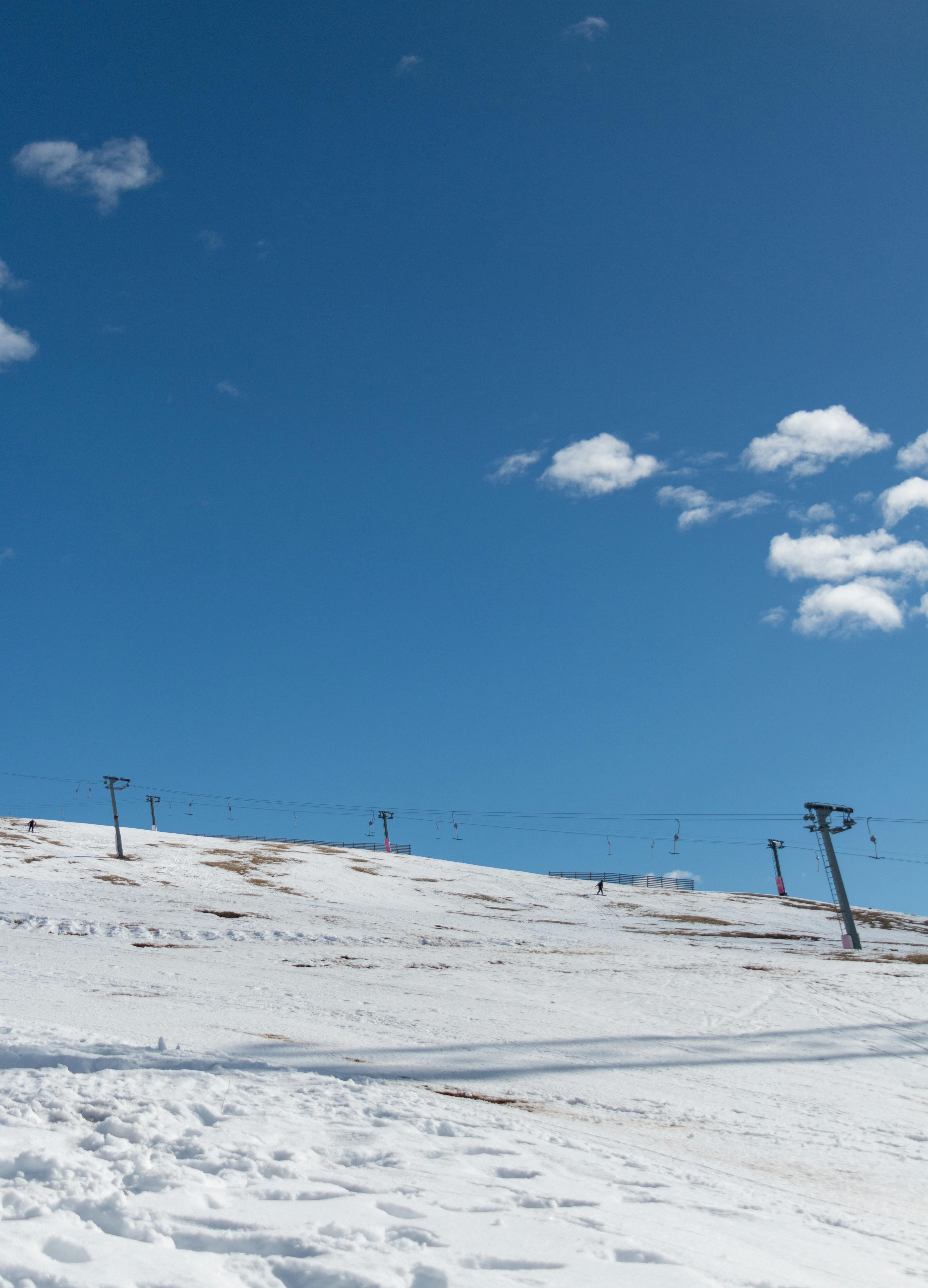 Prescription Goggle Inserts - Snow-covered ski slope in Mavrovo, North Macedonia, featuring ski lifts under a bright blue sky.