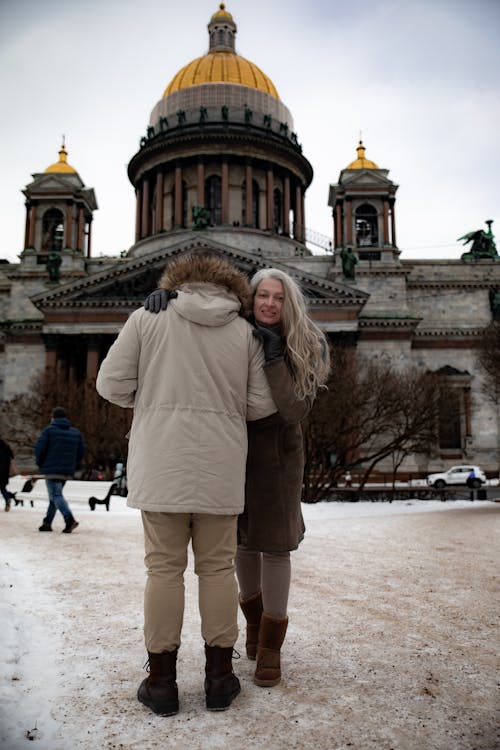 A couple in front of a church in the snow