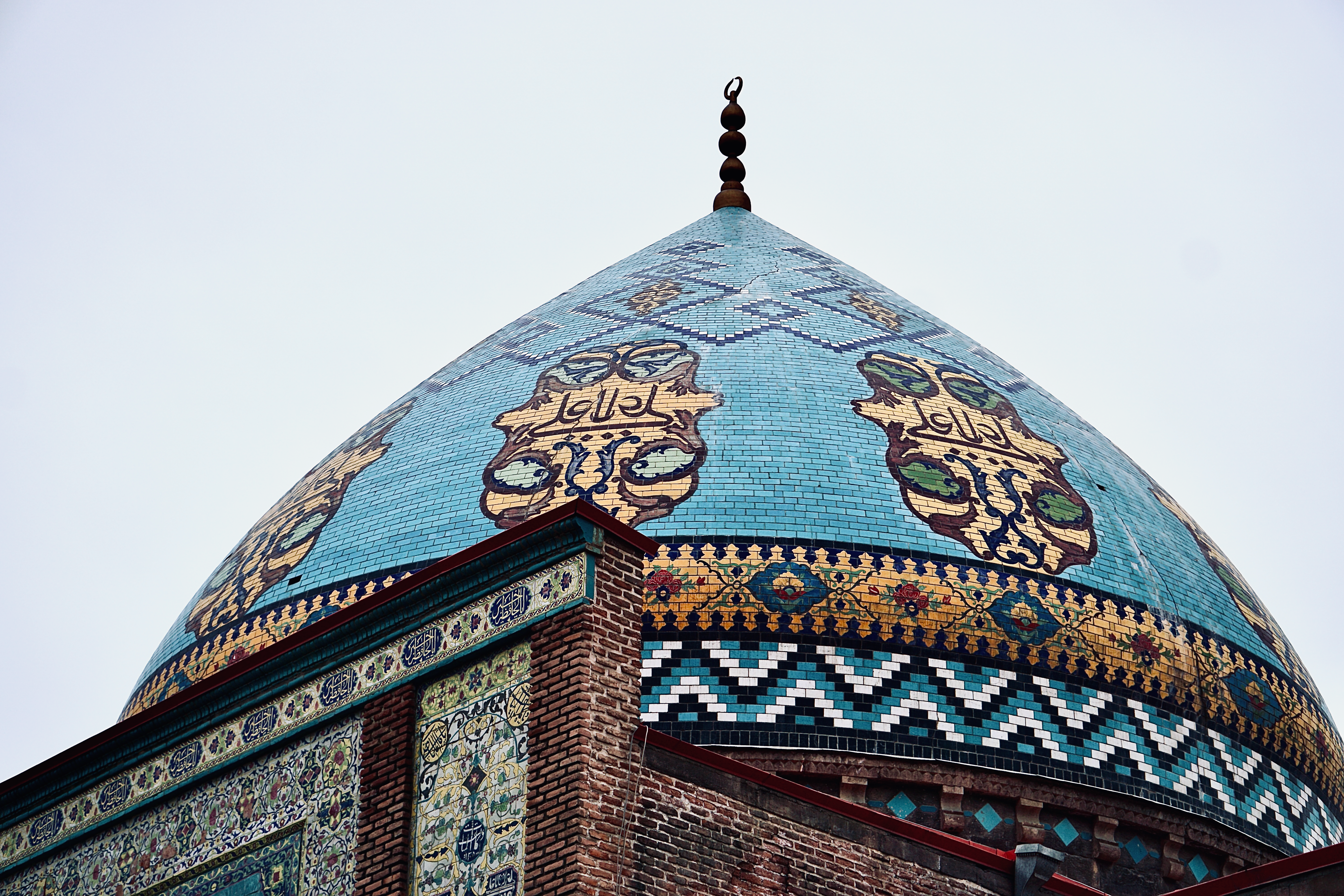 Close-up of an elaborate blue mosque dome showcasing intricate geometric patterns and artistry.