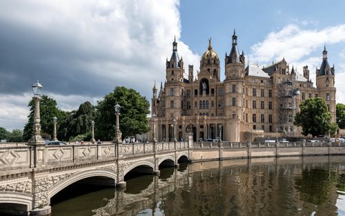 Free Stunning view of Schwerin Castle with its historic bridge and scenic surroundings in Germany. Stock Photo